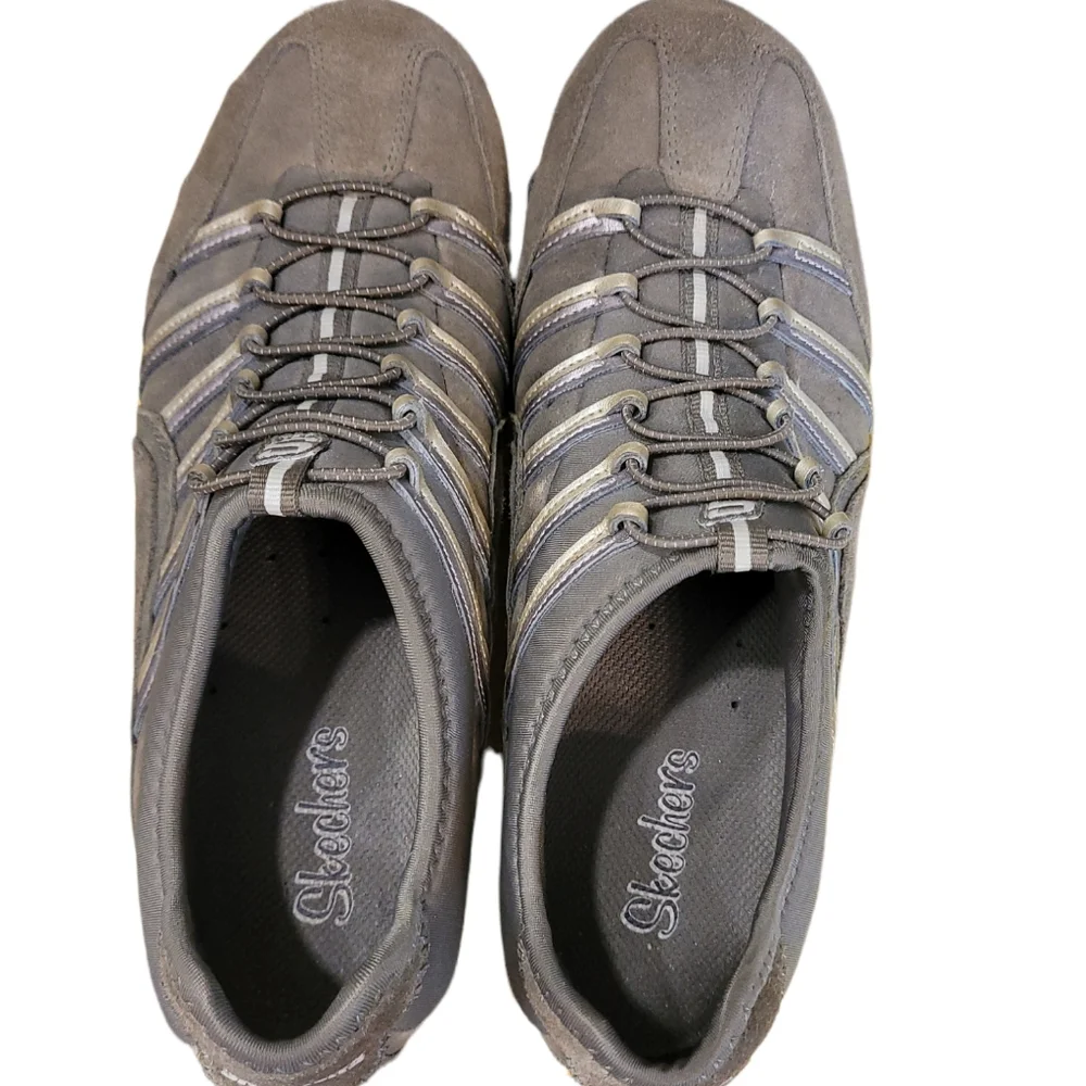 Skechers green outlined with gold ad gray. Slip on.